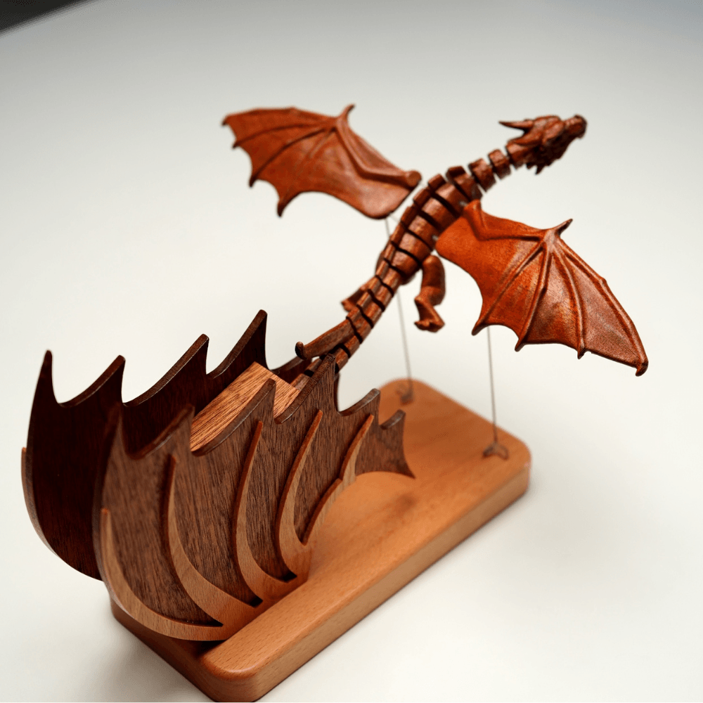 Full view of the wooden Gothic dragon automaton and sculpted flame base on a light background