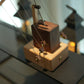 Wooden mechanical model on a reflective surface with blurred background