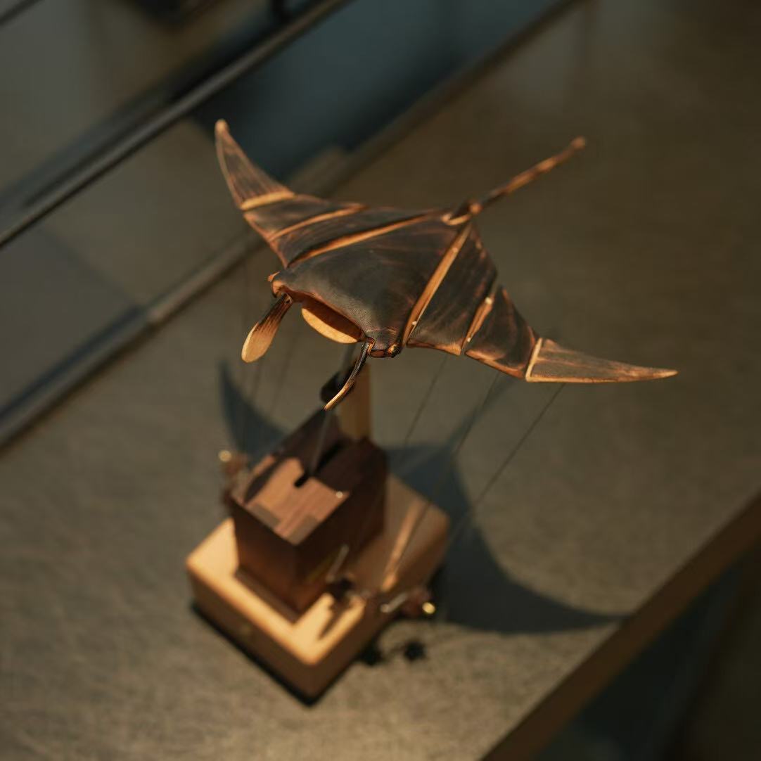 Bronze sculpture of a fish on a wooden base
