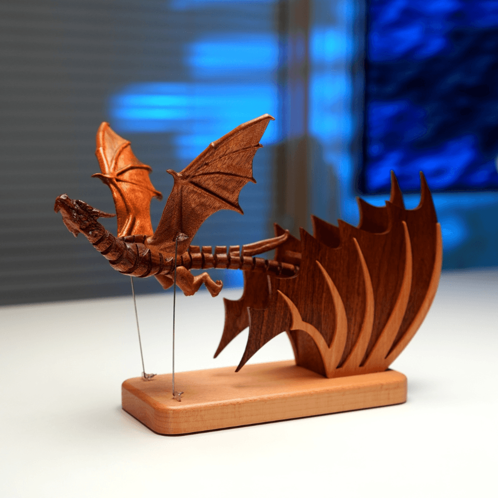 Wooden Gothic dragon automaton with articulated body, raised wings and flame-shaped base